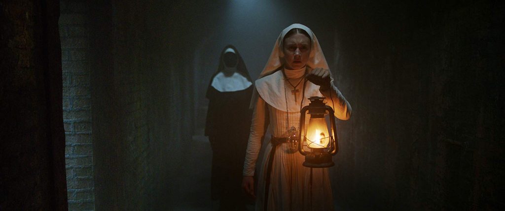 Taissa Farmiga escapes the horrors of Valak in The Nun. | Credit: Warner Bros Pictures